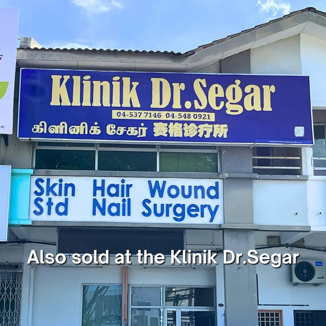 Klinik Dr. SEGAR signboard with contact numbers and services offered on a building.