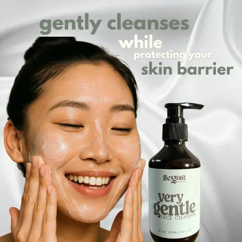 Woman applying facial cleanser with a bottle of Scinic Very Gentle Face Cleanser on a white background