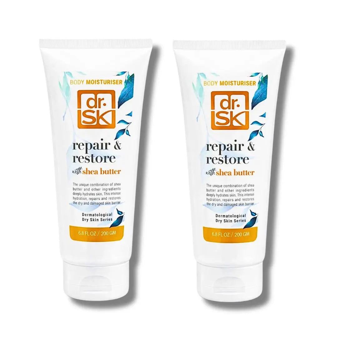 Two tubes of dr. SK repair and restore body moisturiser with shea butter on a white background.